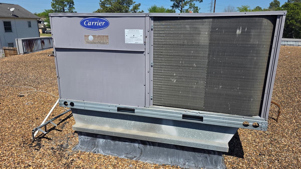 Carrier rooftop packaged HVAC unit installed on a flat commercial roof